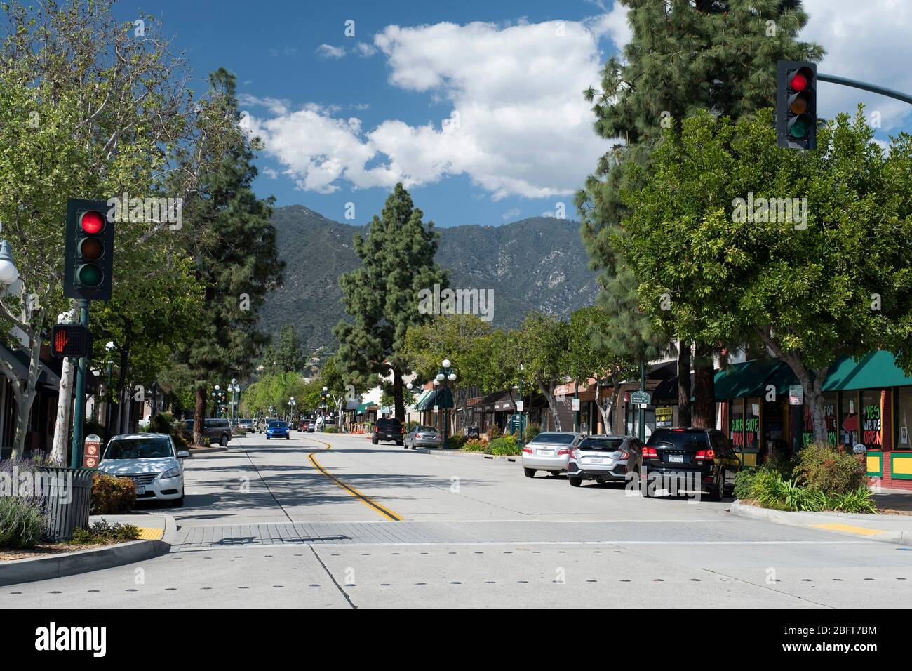 View of Myrtle avenue shopping district in downtown Monrovia, California with the San Gabriel Mountains as a scenic backdrop Stock Photo