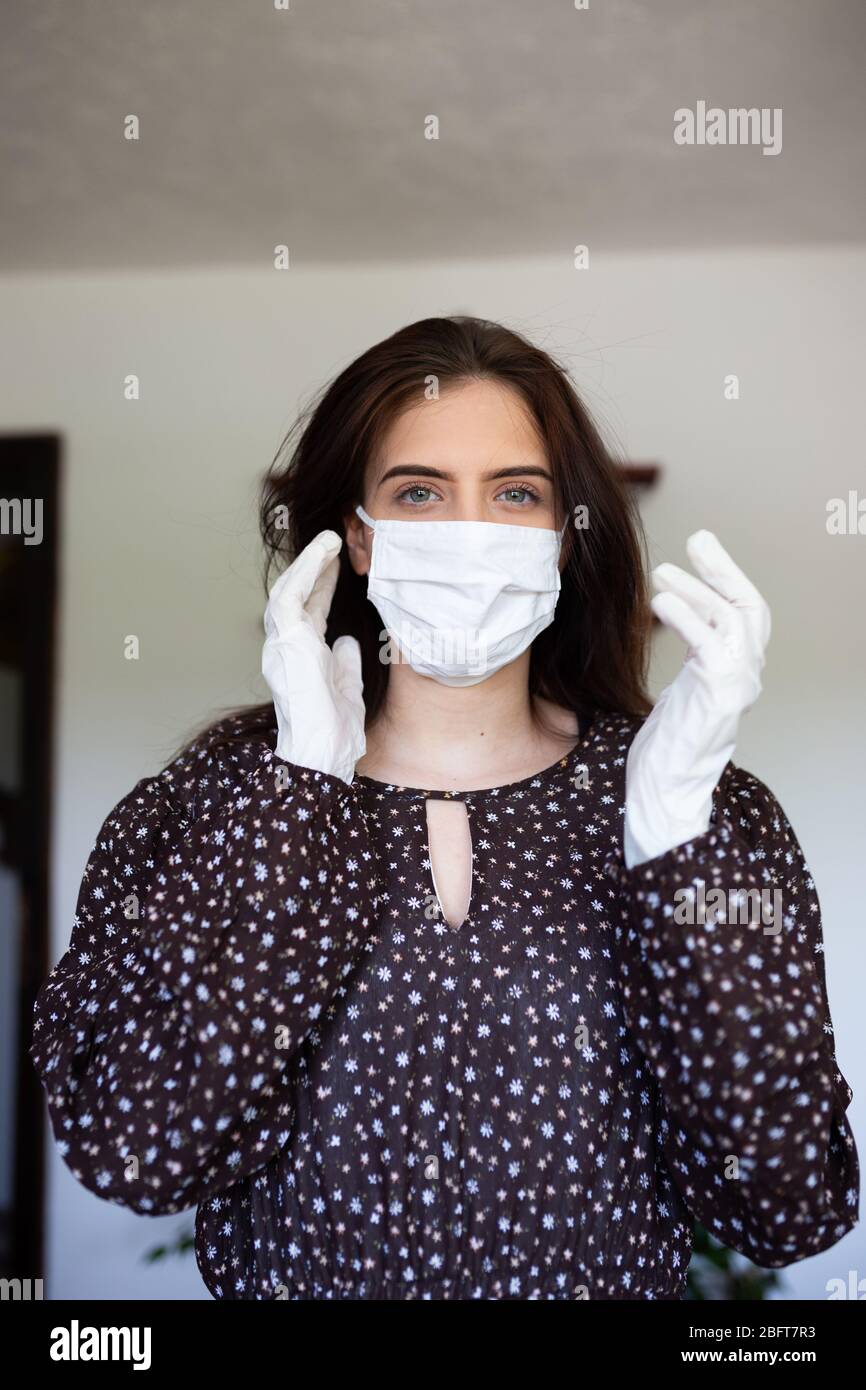 portrait of beautiful young woman wearing cotton white mask and medical ...