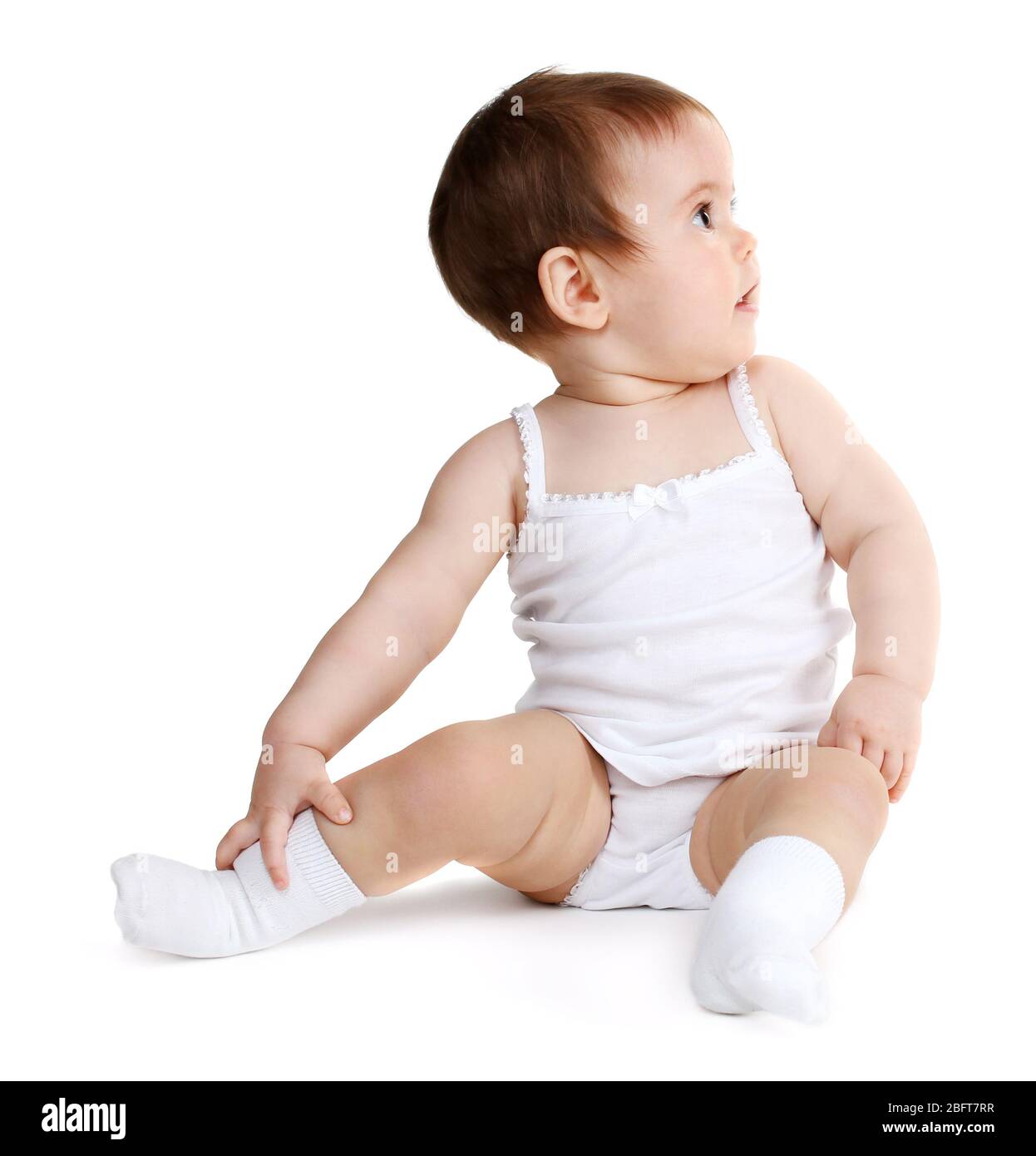 Cute baby girl sitting isolated on white Stock Photo - Alamy