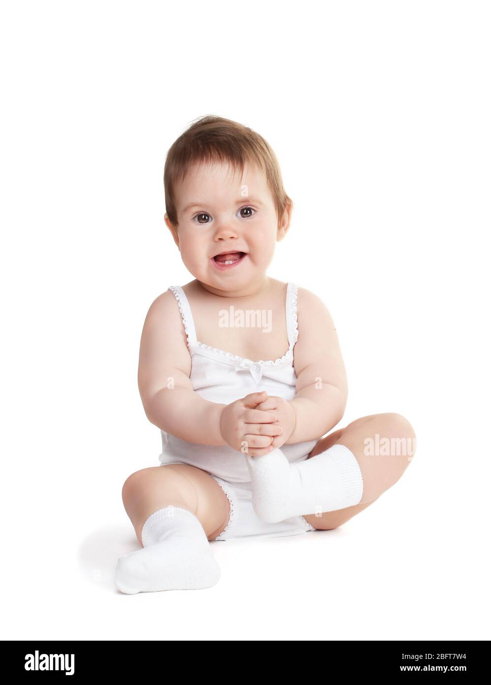 Cute baby girl sitting isolated on white Stock Photo - Alamy