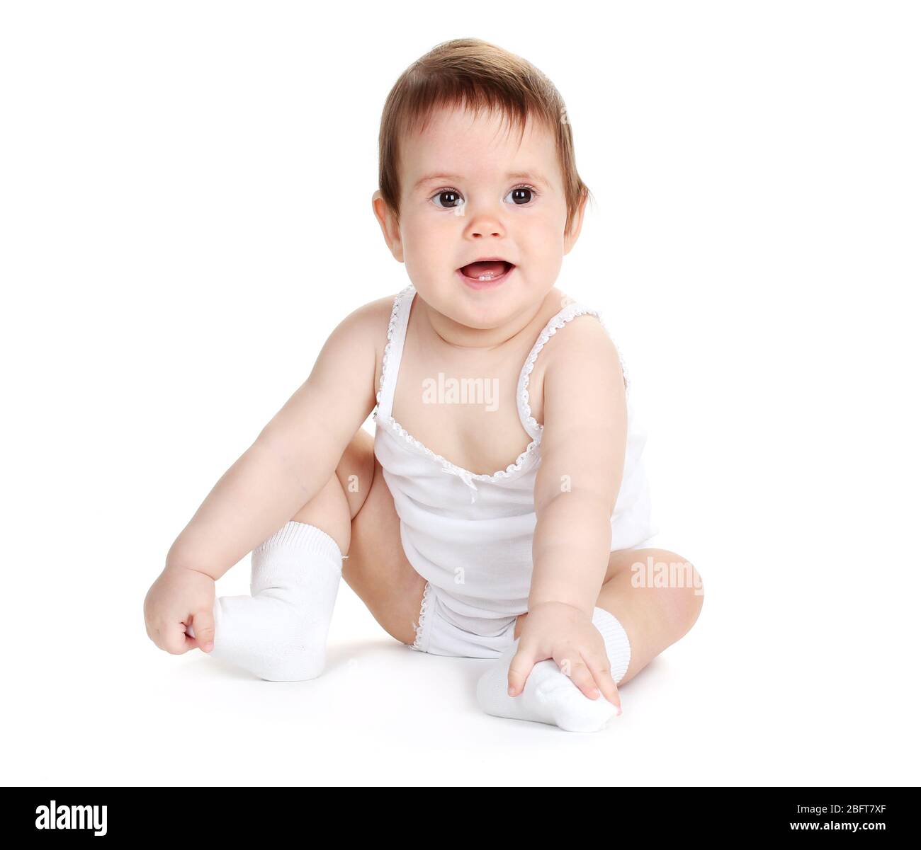 Cute baby girl sitting isolated on white Stock Photo - Alamy