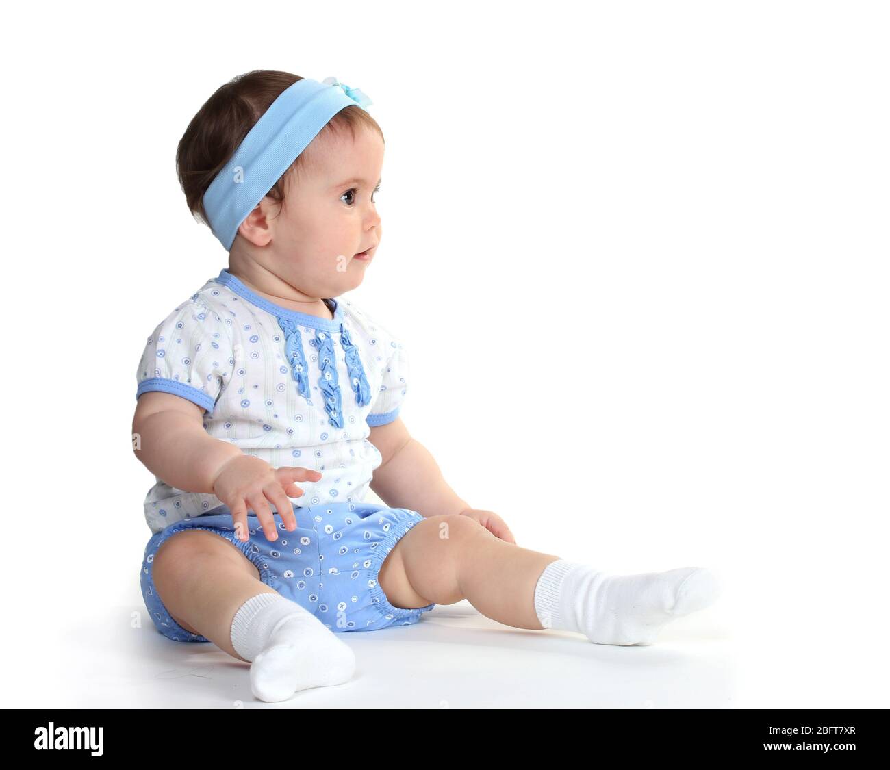 Cute baby girl sitting isolated on white Stock Photo - Alamy