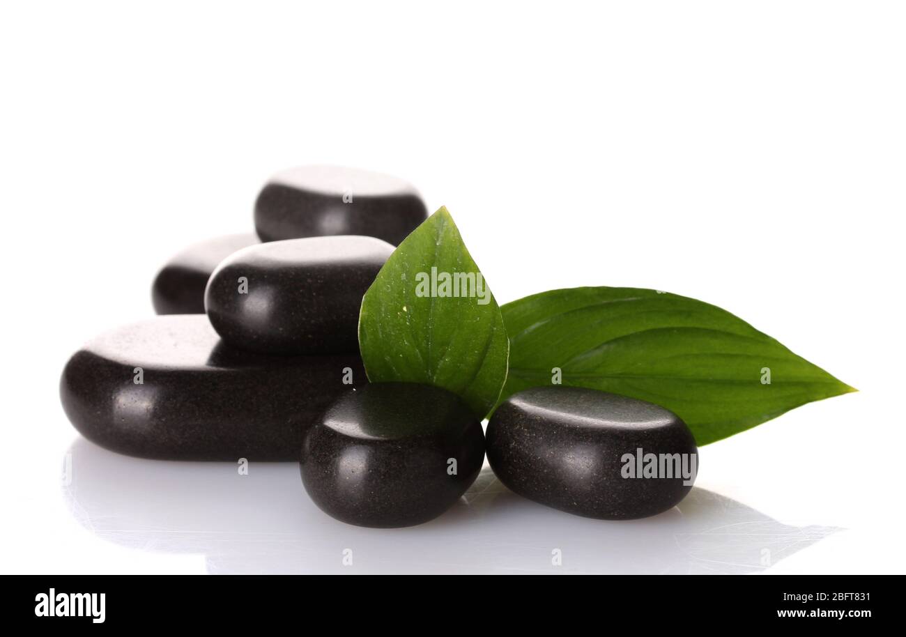 Spa stones and green leaves isolated on white Stock Photo - Alamy