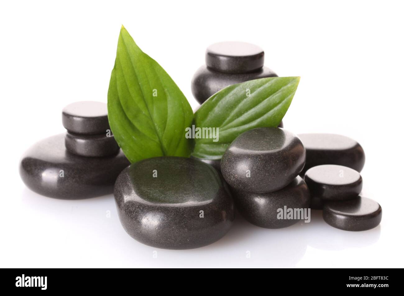 Spa stones and green leaves isolated on white Stock Photo - Alamy