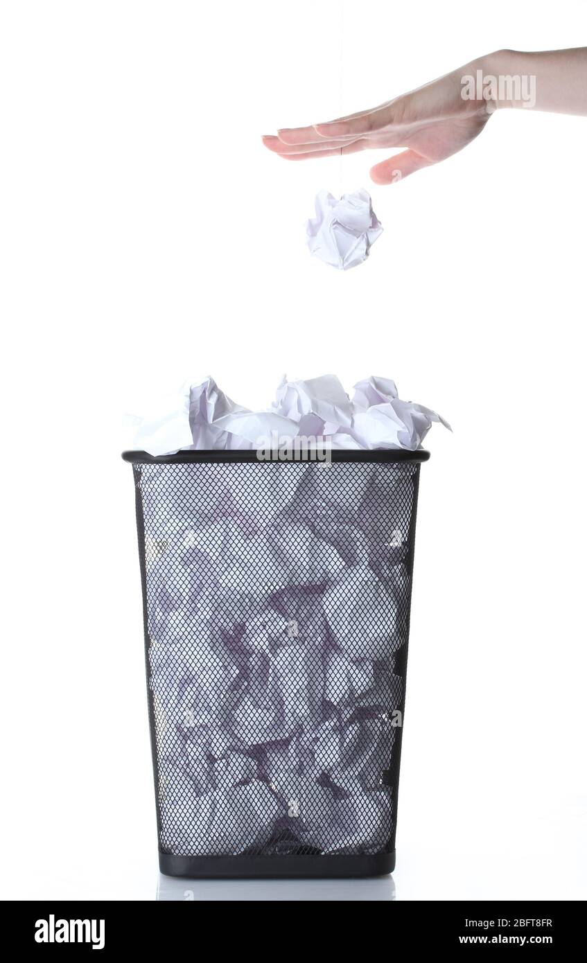 hand going garbage in metal trash bin from paper isolated on white ...