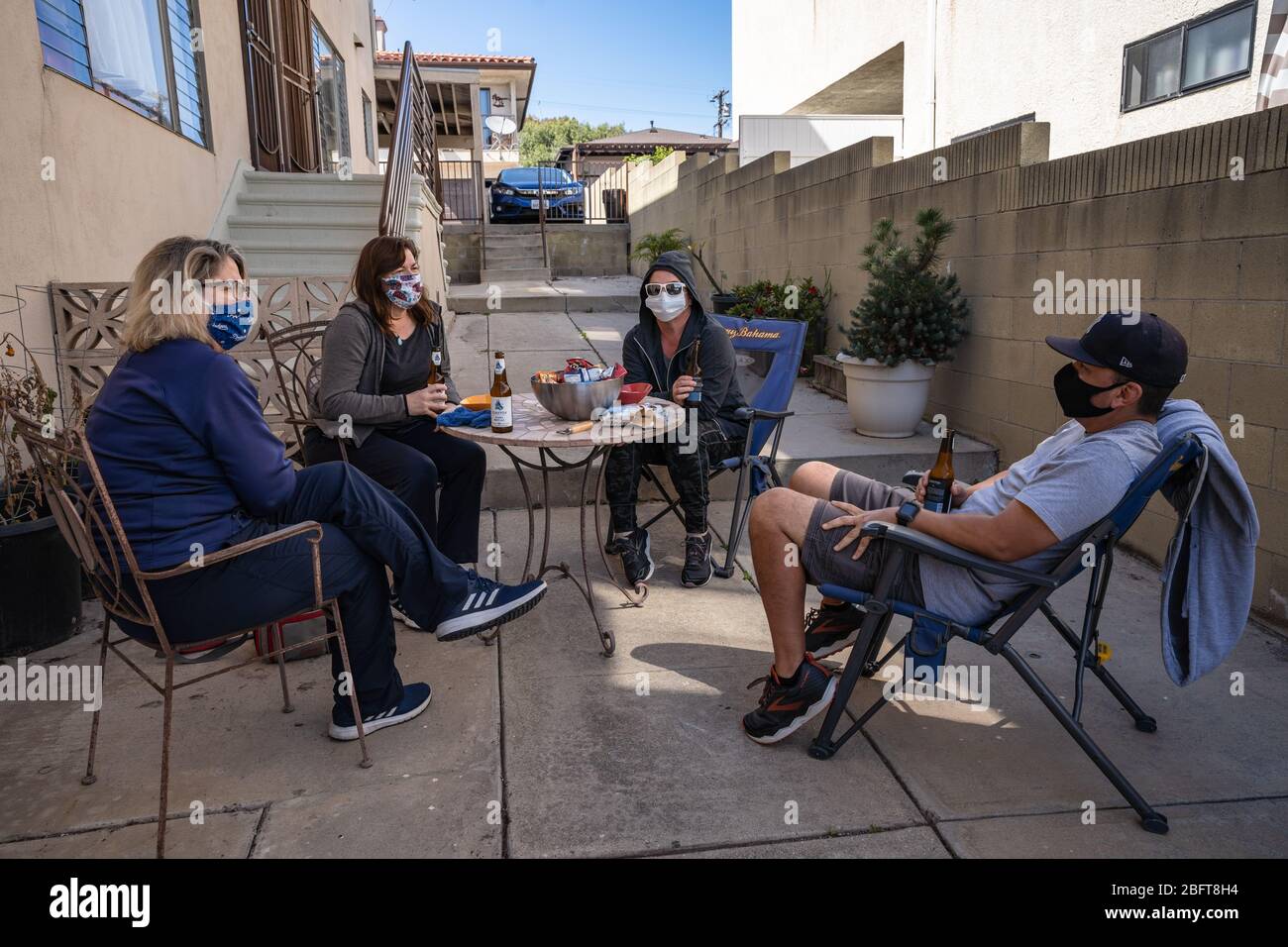 Social distancing party with neighbors in Los Angeles, CA wearing face masks during Covid-19 crisis Stock Photo