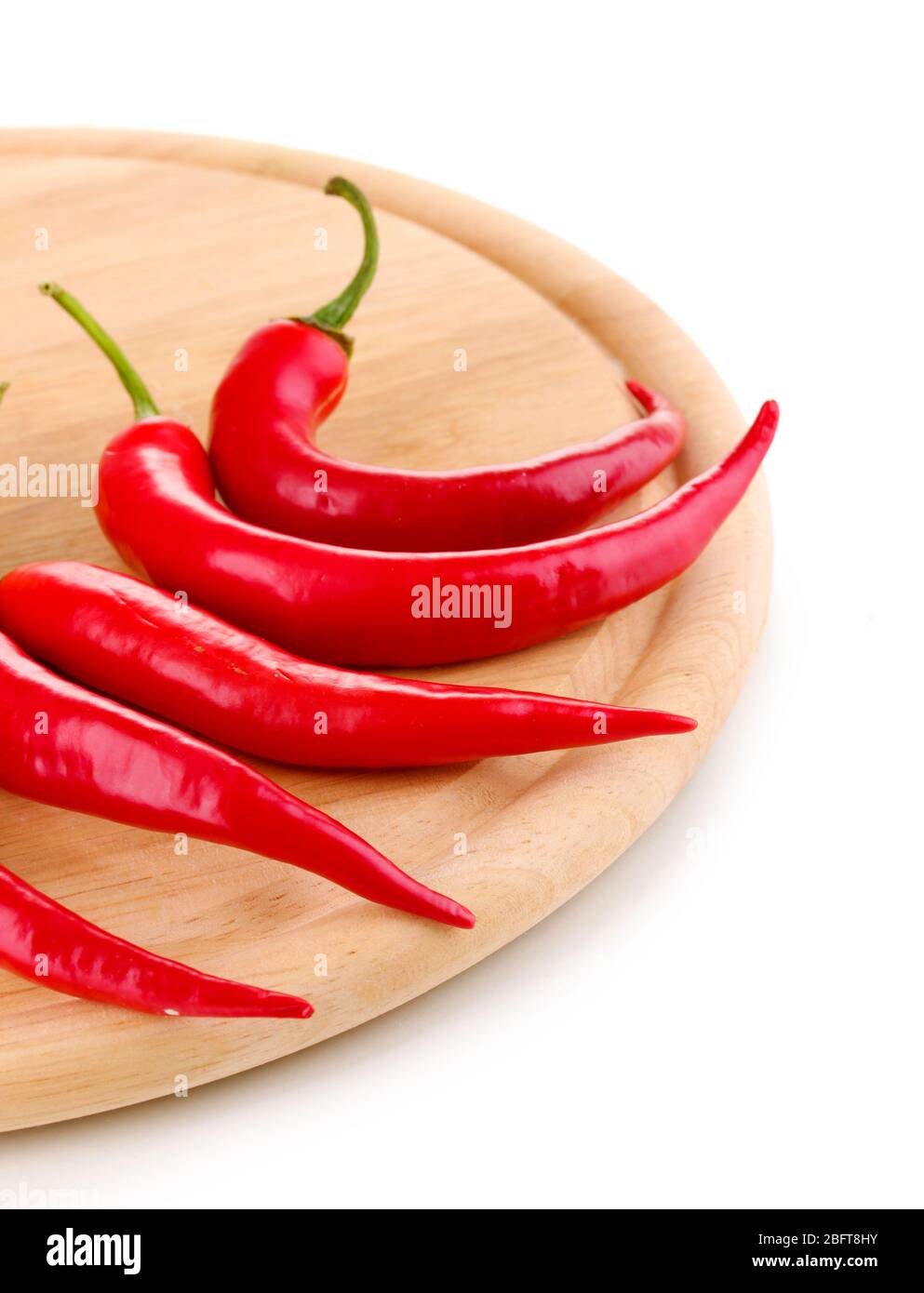 Red hot chili peppers on wooden plank isolated on white Stock Photo - Alamy
