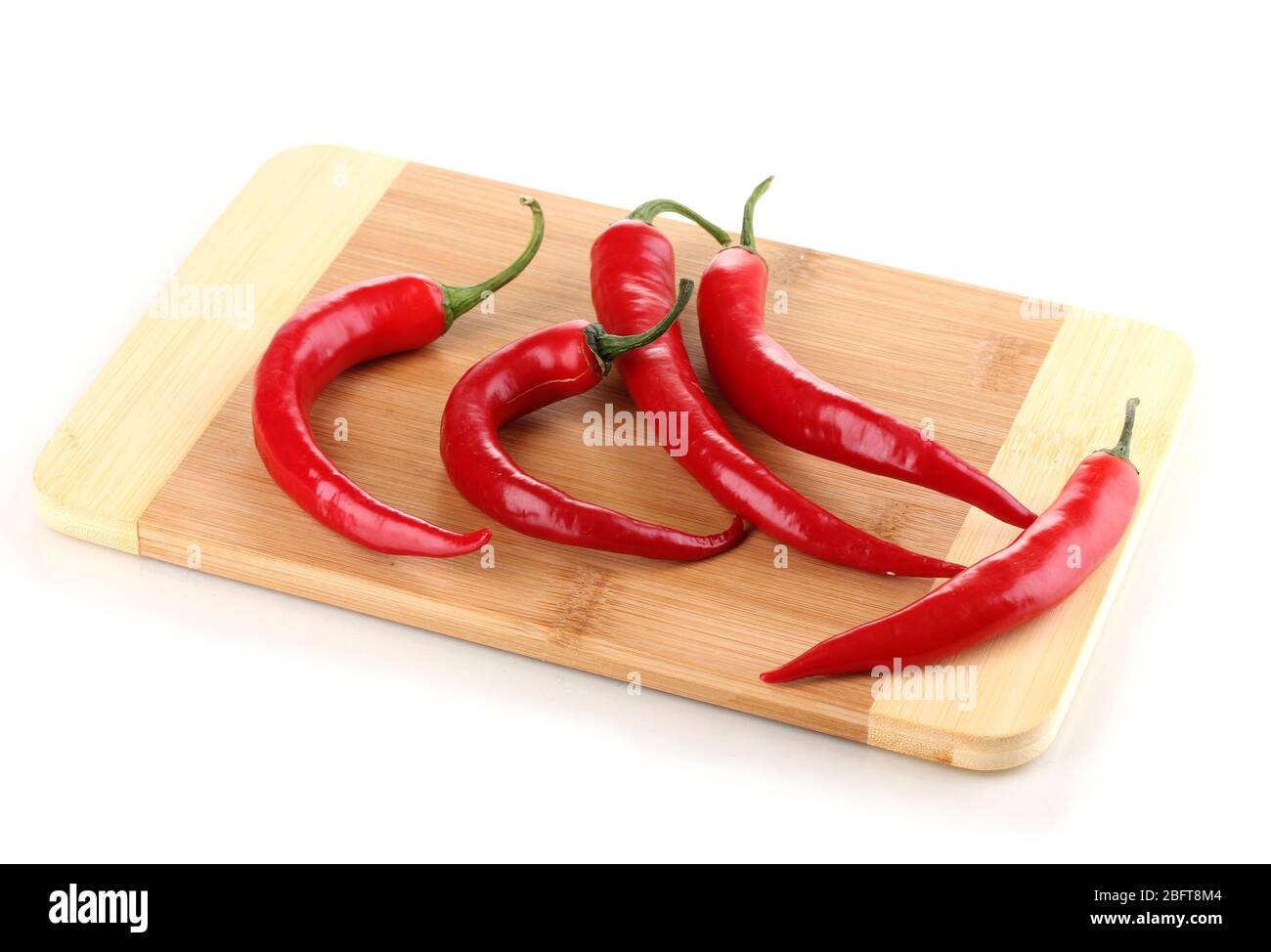Red hot chili peppers on wooden plank isolated on white Stock Photo - Alamy