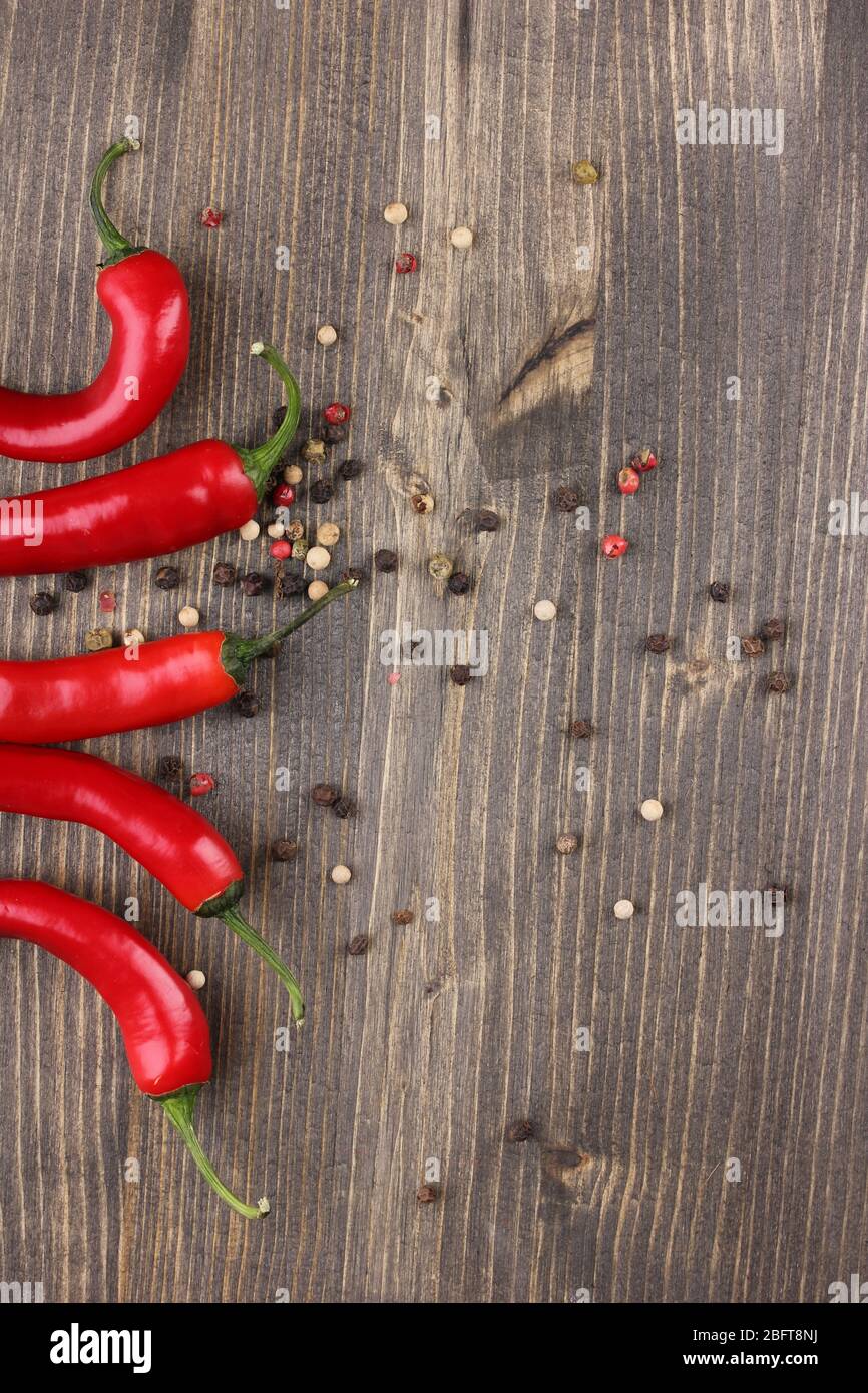Red hot chili peppers on wooden background Stock Photo - Alamy