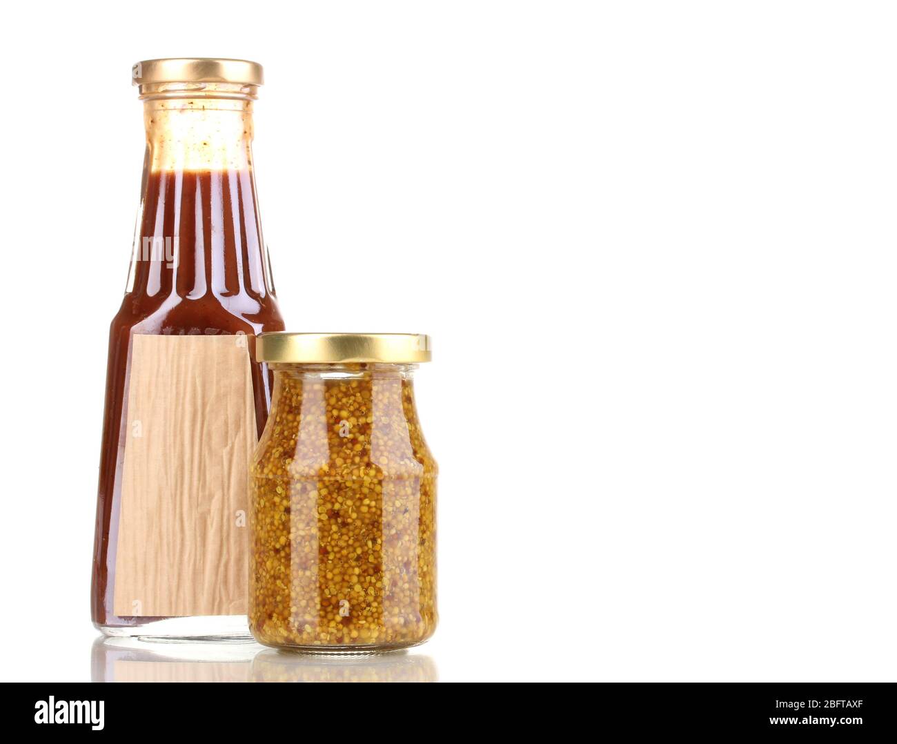 Tomato sauce and mustard in glass bottles isolated on white Stock Photo