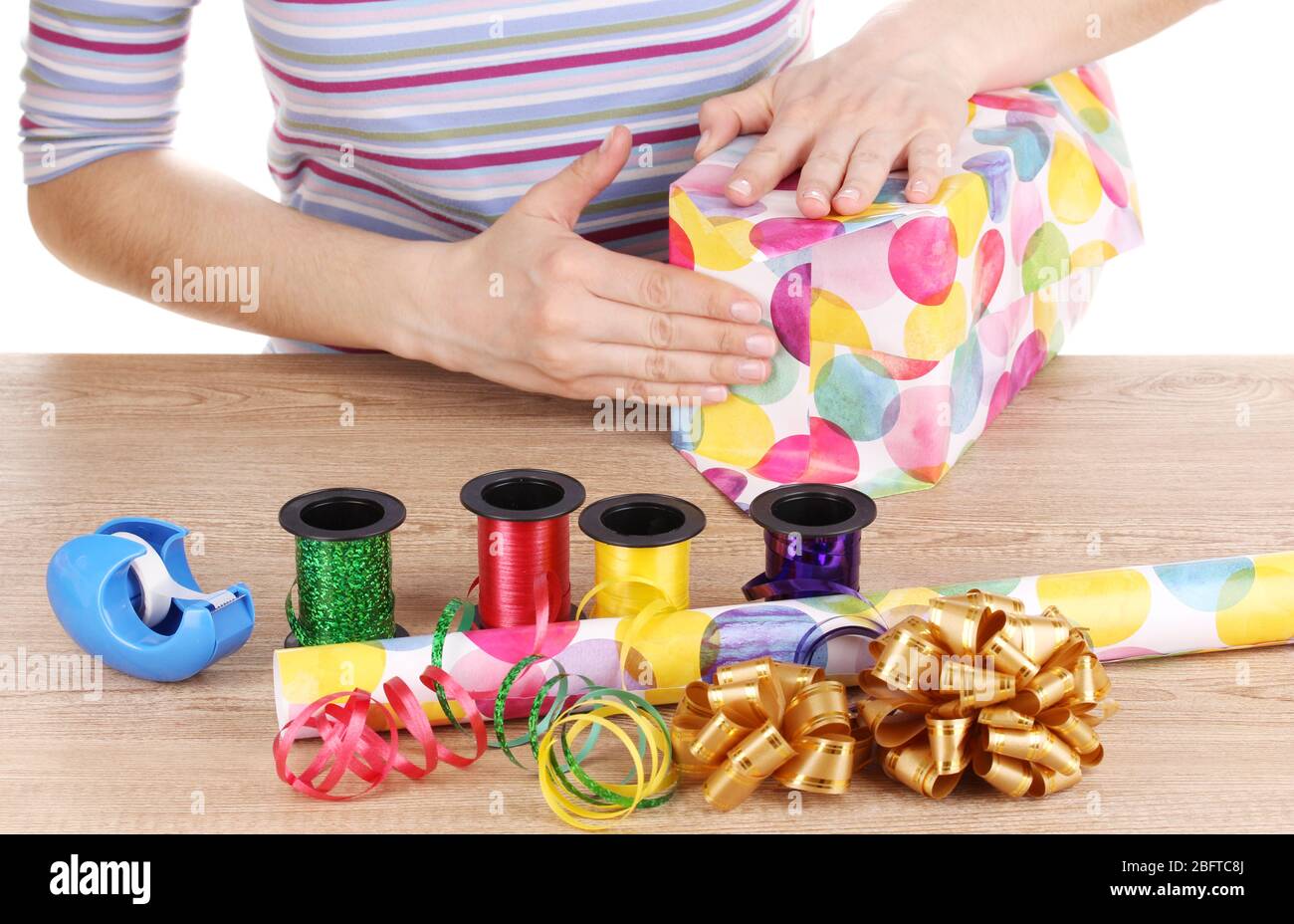 Wrapping presents surrounded by paper, ribbon and bows Stock Photo - Alamy