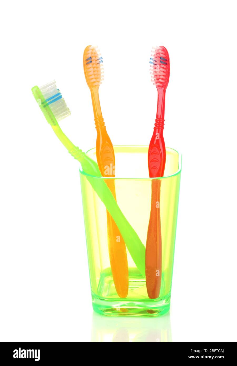 Toothbrushes in glass isolated on white Stock Photo - Alamy