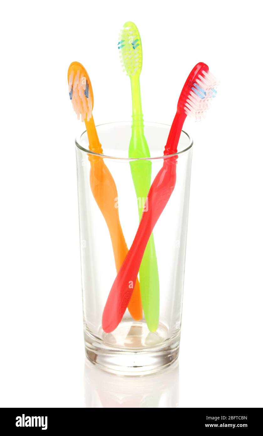 Toothbrushes in glass isolated on white Stock Photo - Alamy