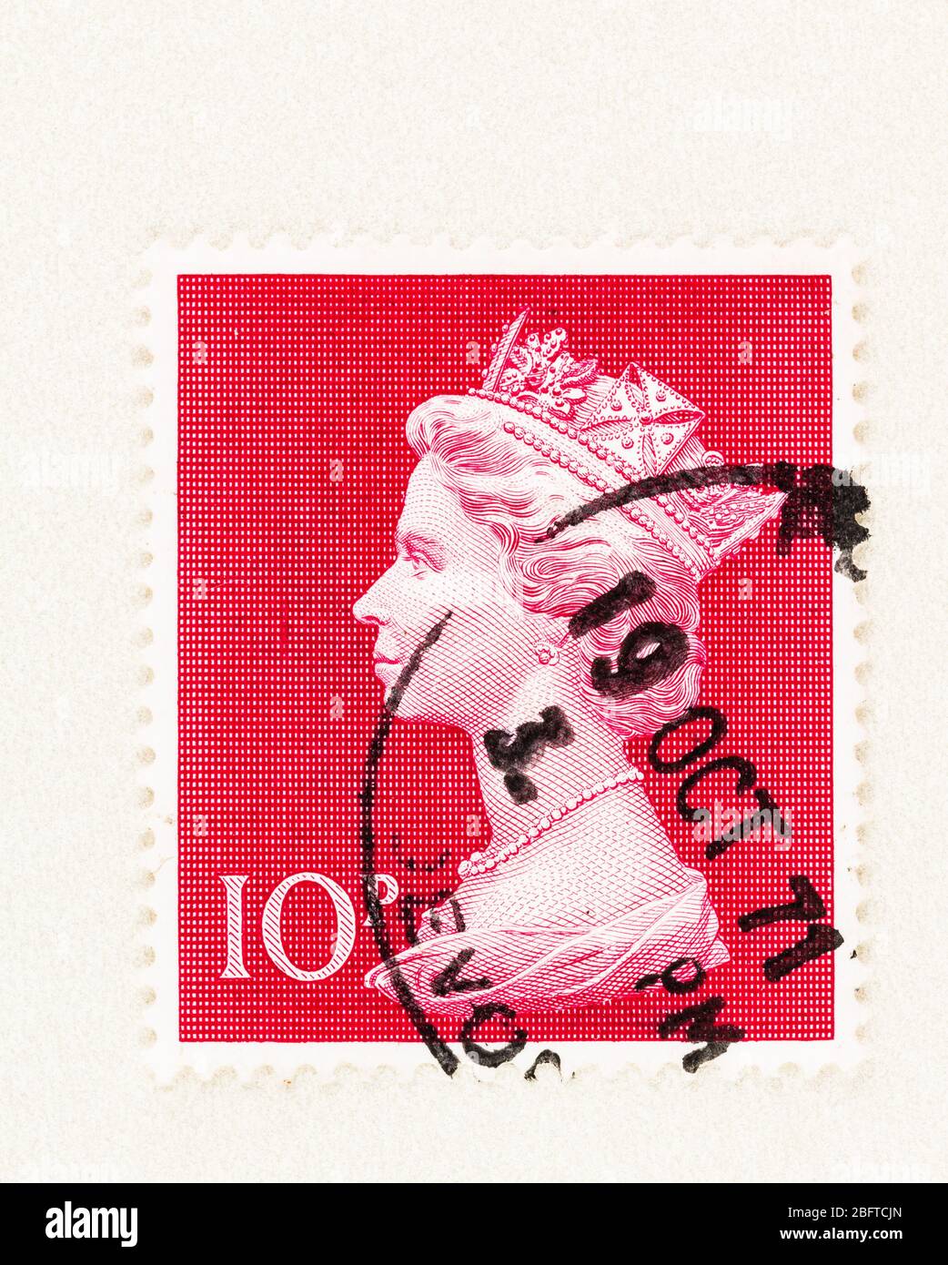 SEATTLE WASHINGTON - April 18, 2020: Close up of cerise red Large Machin 1970 Stamp of Great Britain, featuring 10 penny Queen Elizabeth II bust in pr Stock Photo