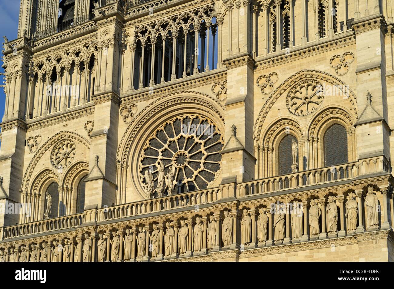 The glowing facade of Notre Dame de Paris on a summer evening, Paris FR Stock Photo