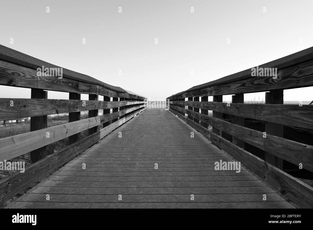 Walkway to beach in black and white Stock Photo