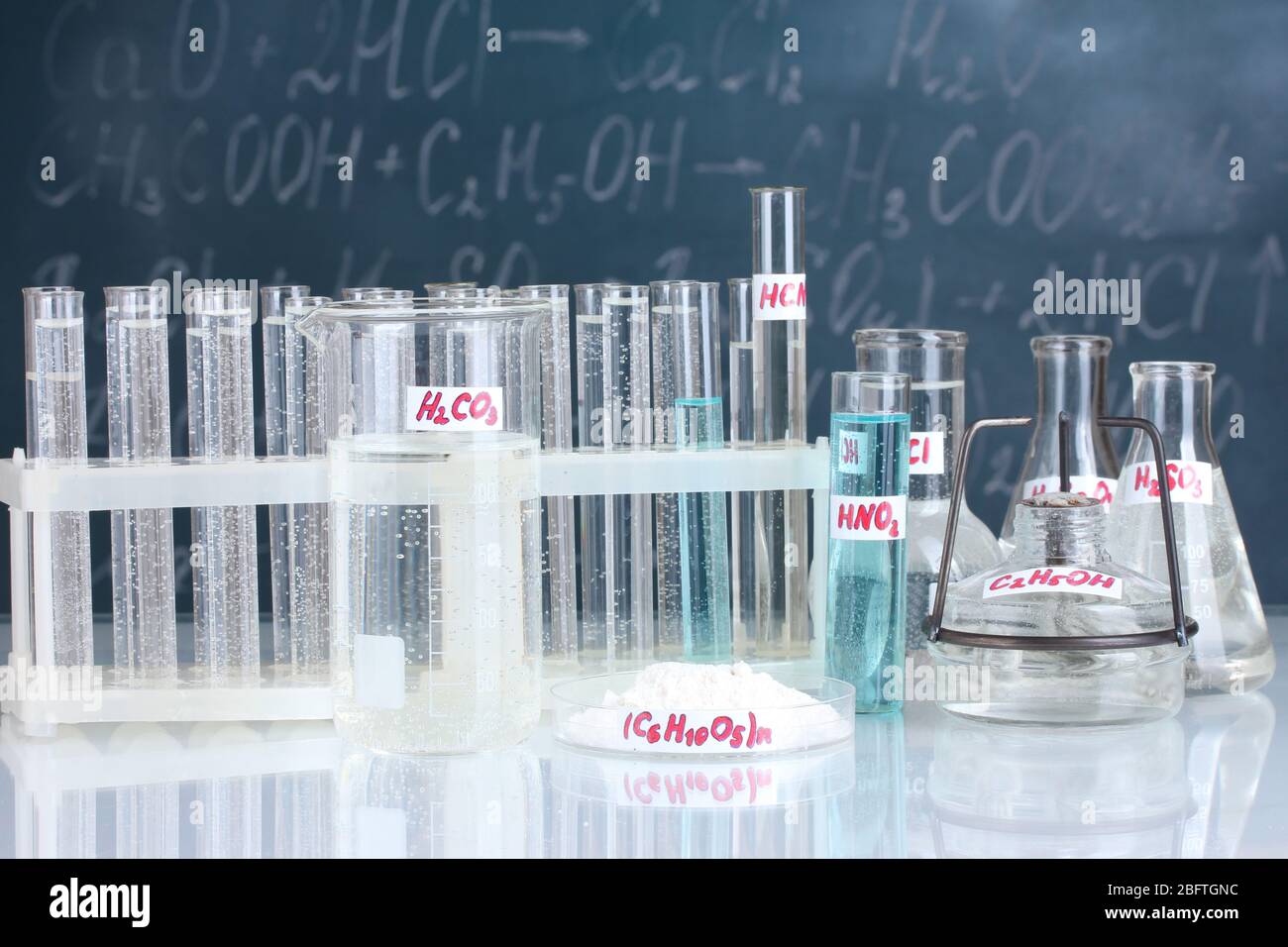 Test-tubes with various acids and other chemicals on the background of ...