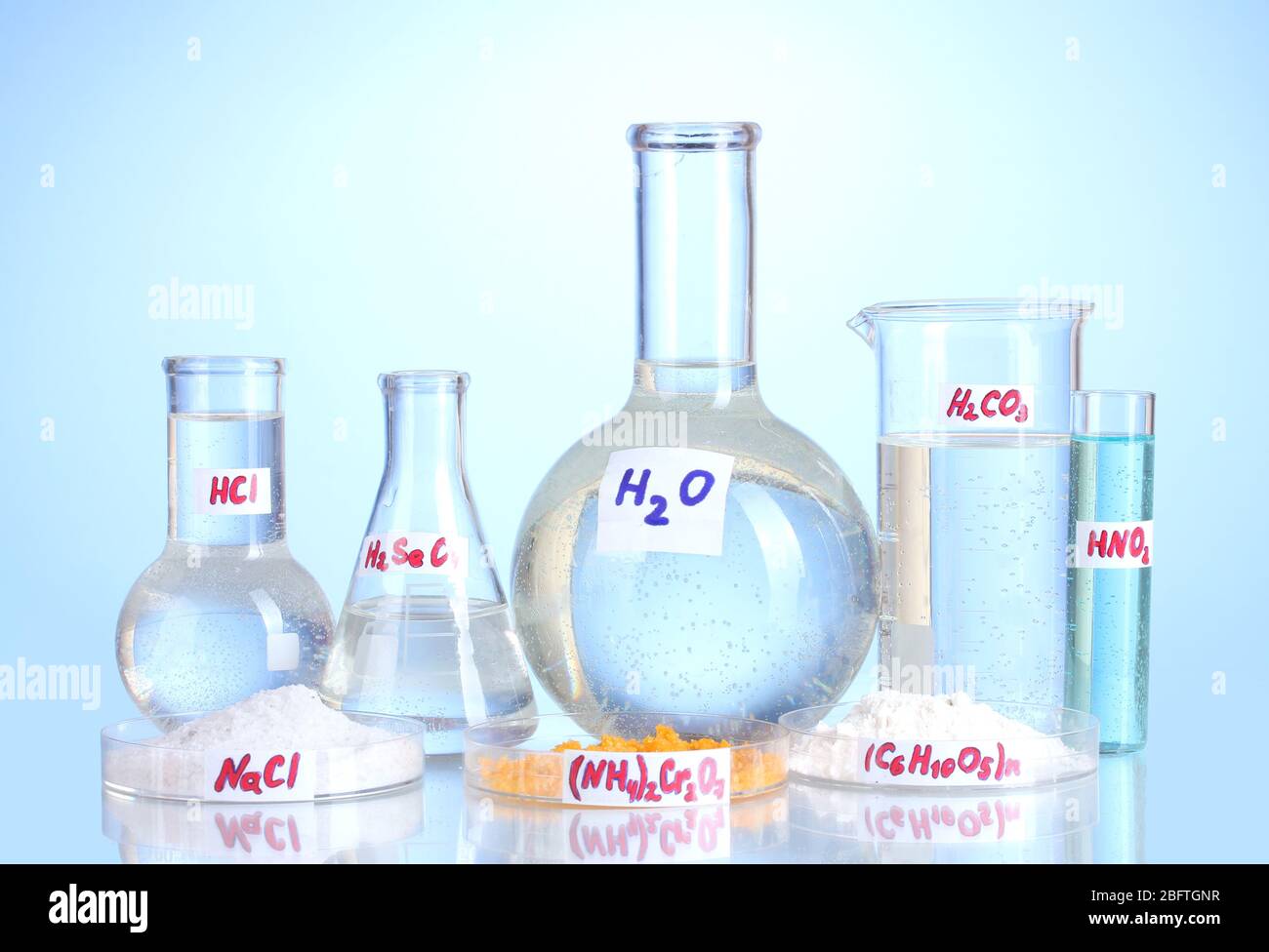 Test-tubes with various acids and chemicals on blue background Stock ...
