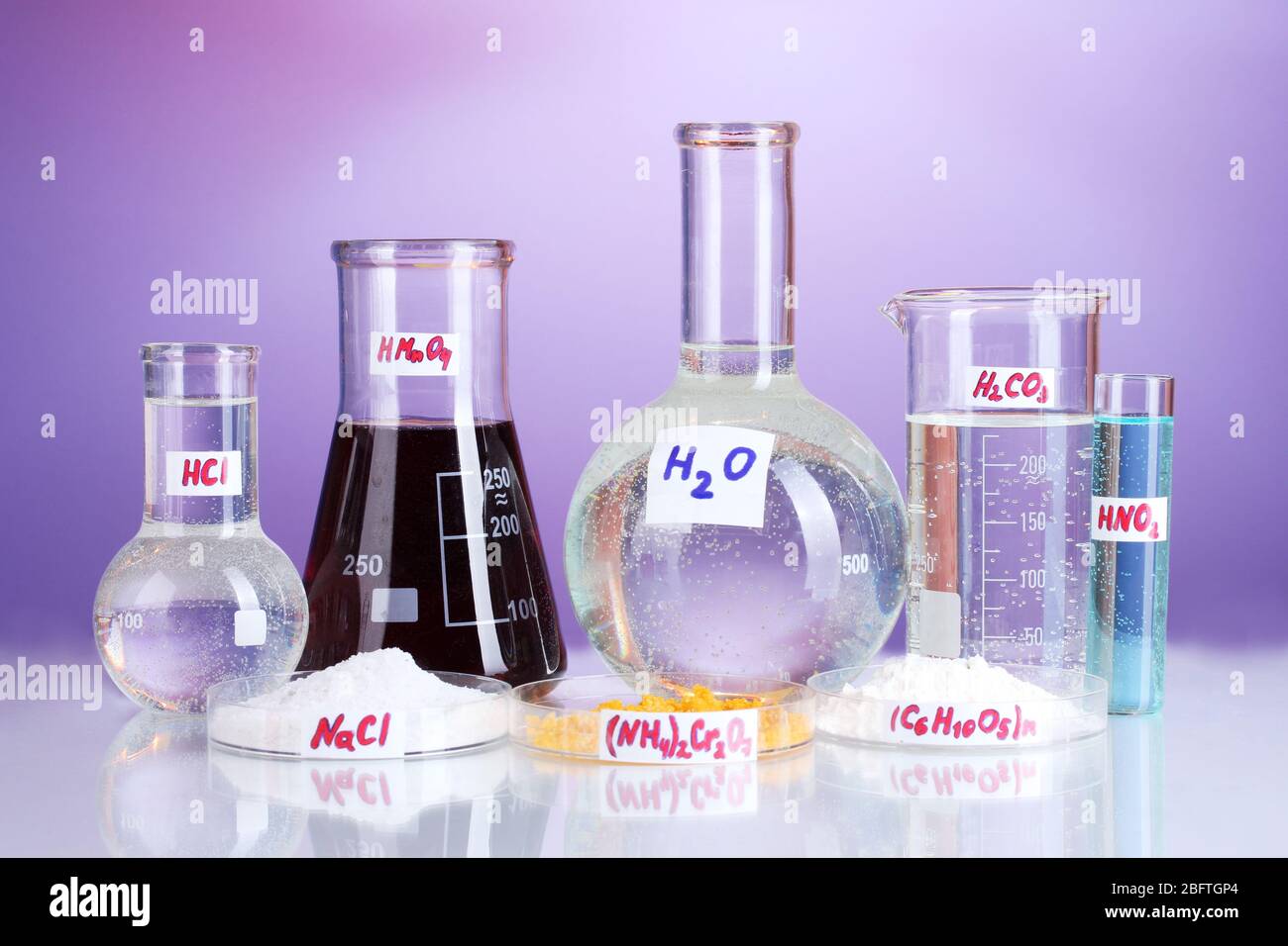 Test-tubes with various acids and chemicals on violet background Stock ...