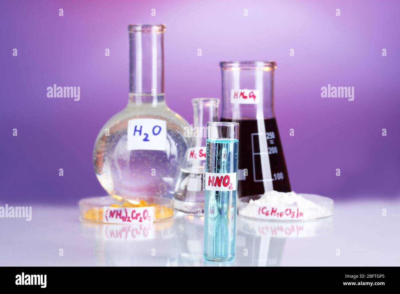 Test-tubes with various acids and chemicals on violet background Stock ...