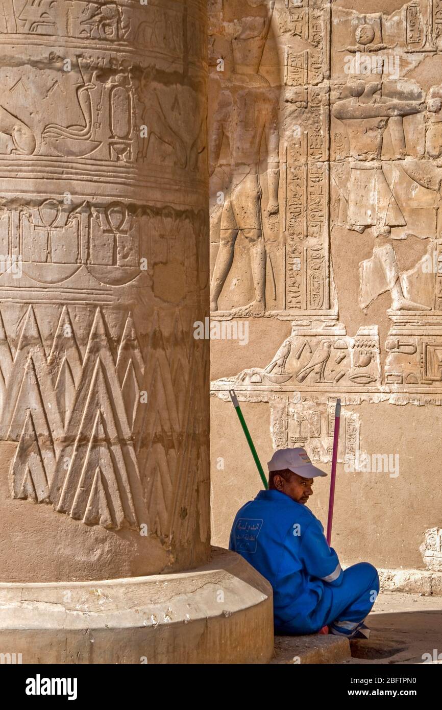 A Worker Takes a Break at the Temple of Horus in Edfu, Egypt. Stock Photo