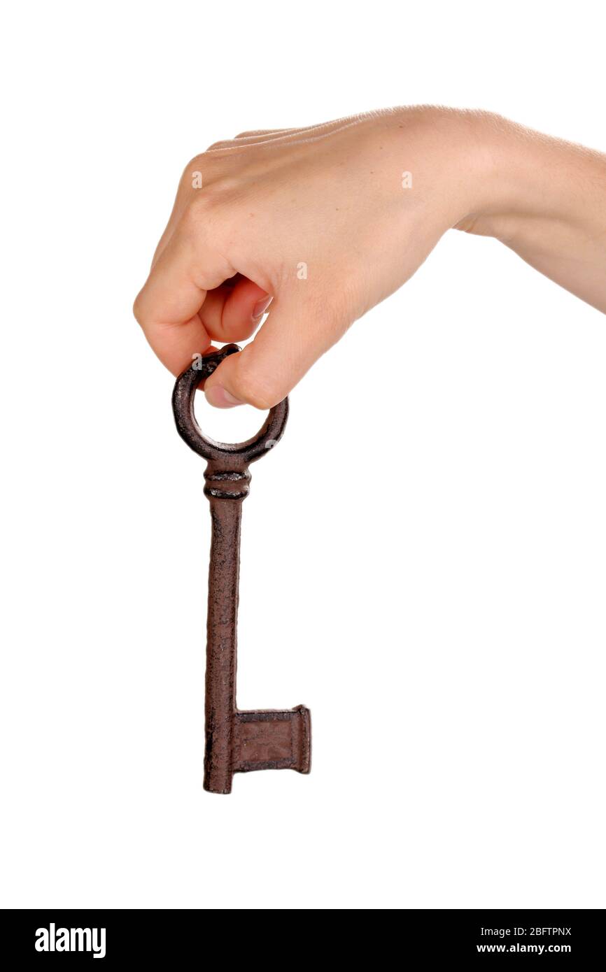 woman's hand holding an antique key on white background Stock Photo - Alamy