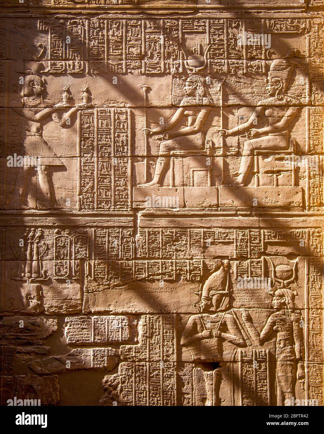 Hieroglyphics Reliefs on a wall at the Temple of Philae, Aswan, Egypt. Stock Photo