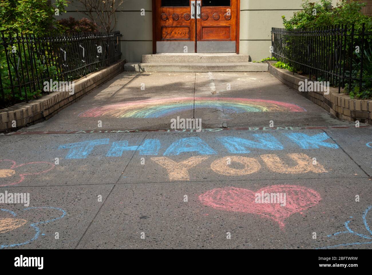 New York, NY, USA. April 19, 2020. Thank You messages of support written in chalk on the sidewalk outside of an apartment building on the Upper West S Stock Photo