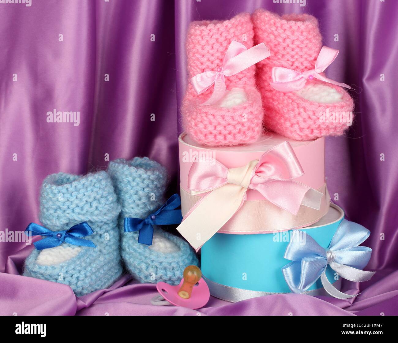 pink and blue baby boots, pacifier and 