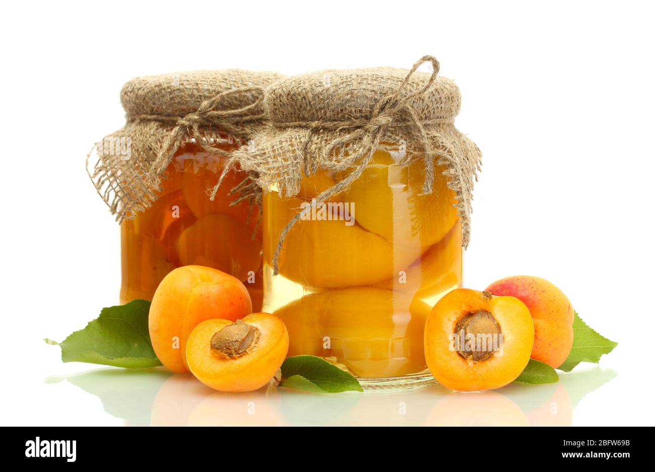 canned apricots in a jars and sweet apricots isolated on white Stock