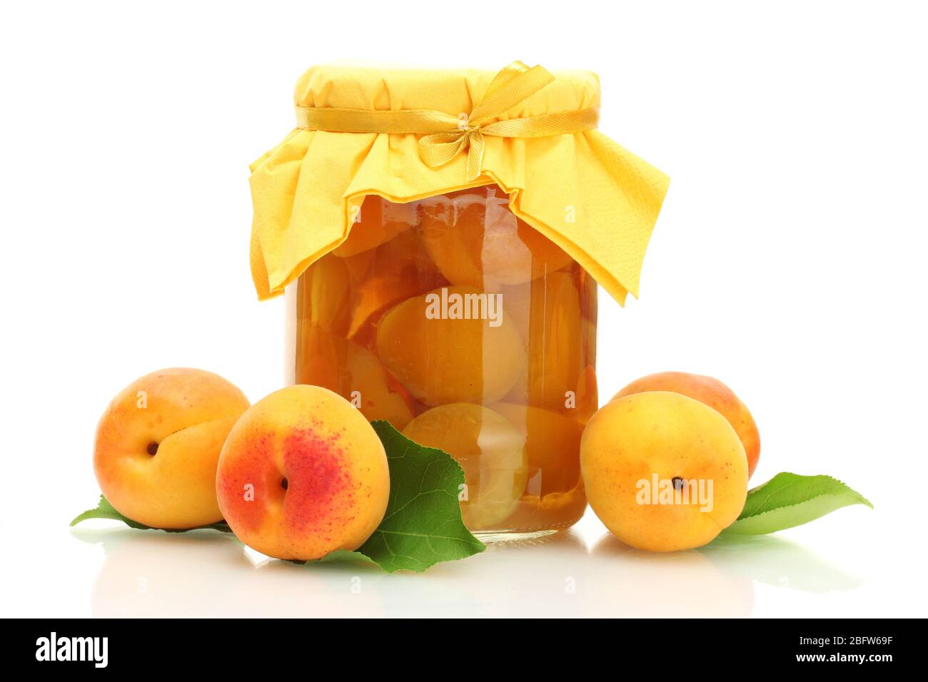 canned apricots in a jar and sweet apricots isolated on white Stock