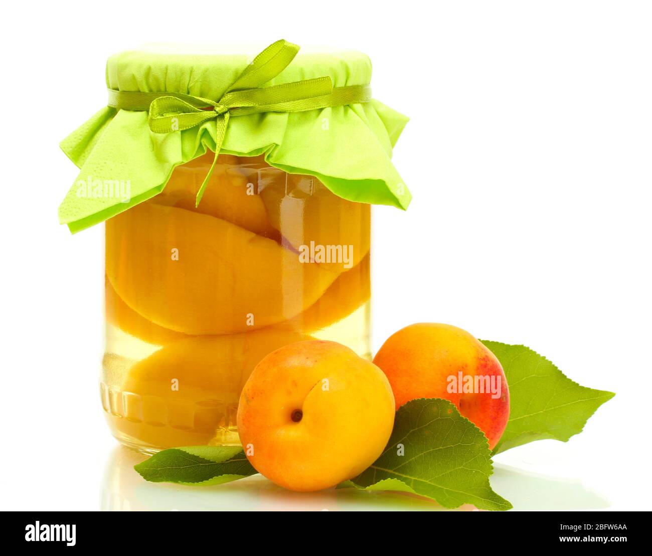 canned apricots in a jar and sweet apricots isolated on white Stock