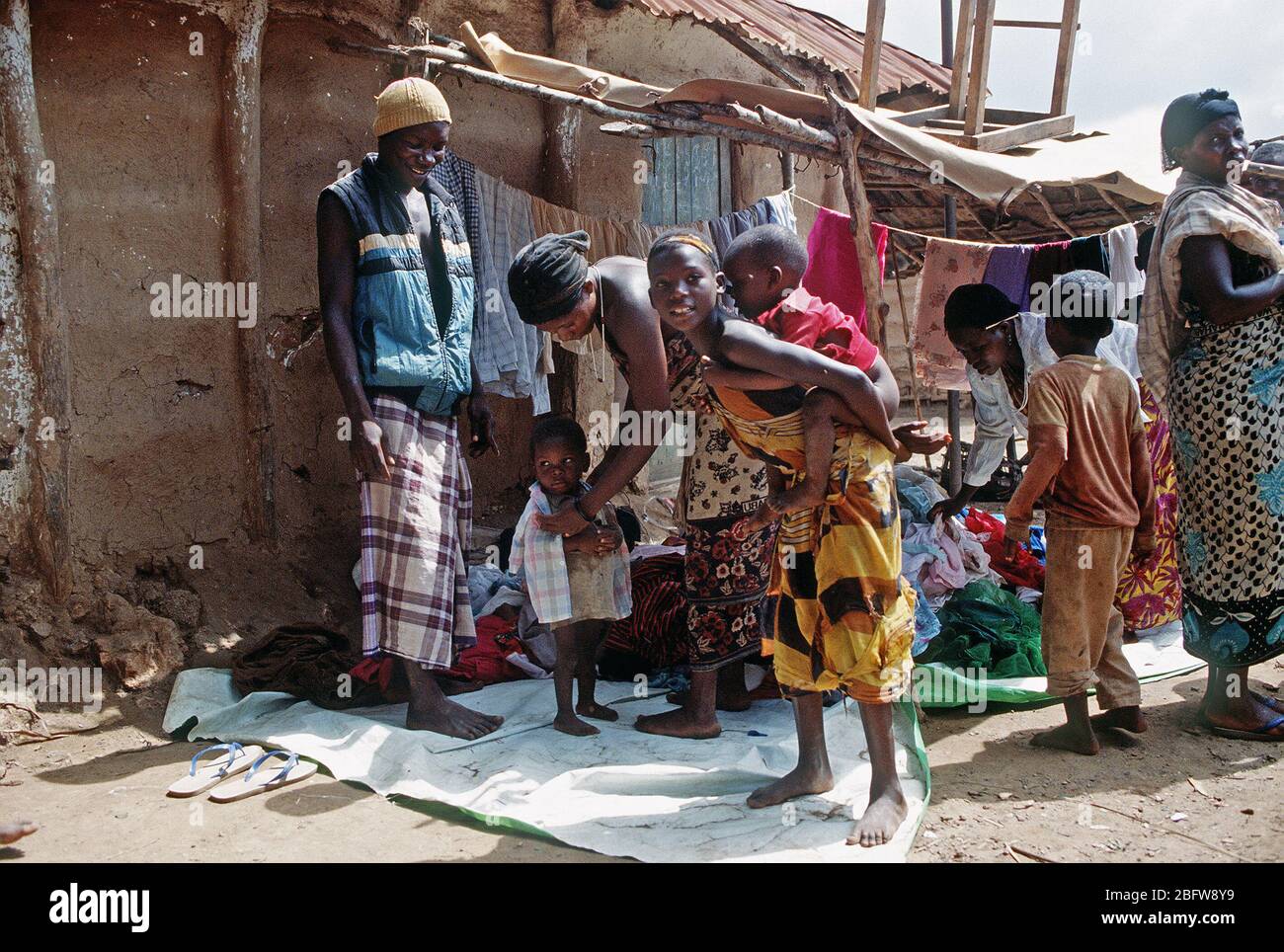 1993 - A little child tries on a shirt in the market in Mogambo village in Somalia during operation Continue Hope. Stock Photo