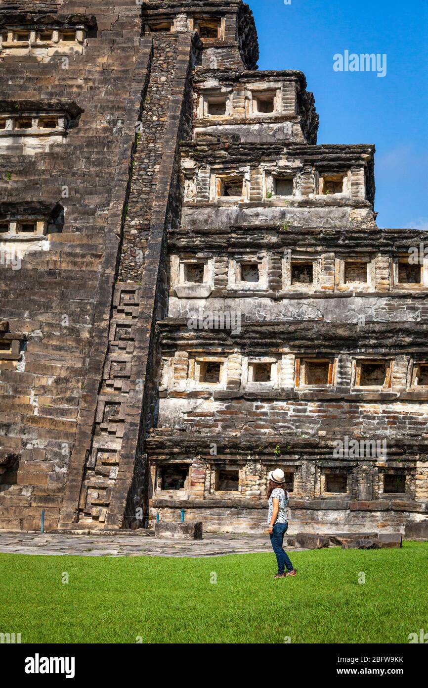 A young woman admires the Niches Pyramid in Tajin, Veracruz, Mexico. Stock Photo