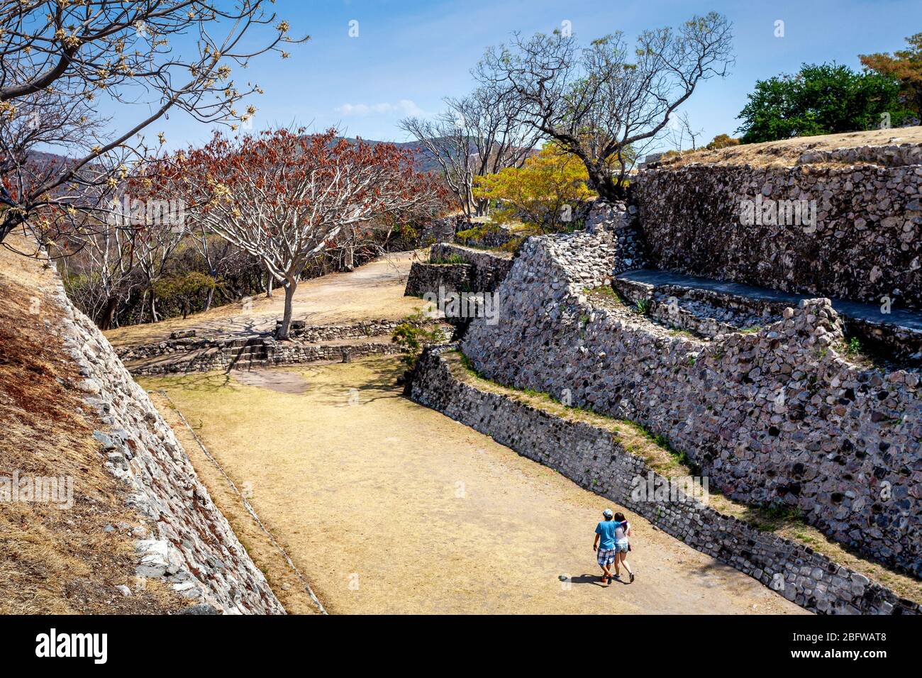 A couple explores a ball court in the Xochicalco Ruins of Morelos