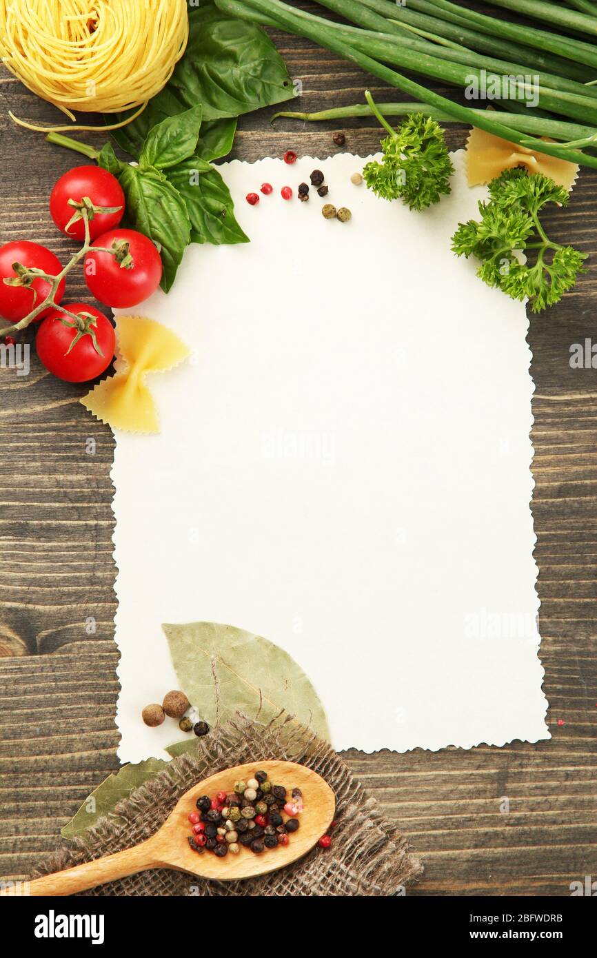 paper for recipes vegetables, and spices on wooden table Stock Photo ...