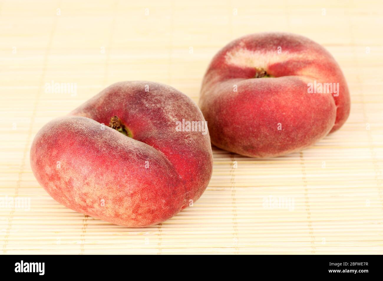 ripe fig peaches on bamboo mat Stock Photo