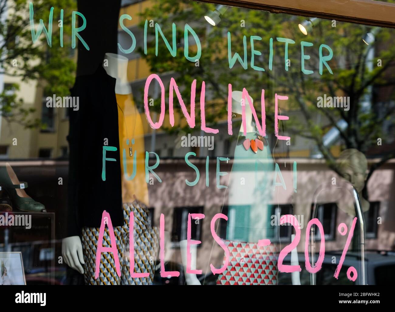 Berlin, Germany. 15th Apr, 2020. 'We're still there for you online! Alles 20 Prozent' is written on a shop window of a fashion store in Prenzlauer Berg. Credit: Jens Kalaene/dpa-Zentralbild/ZB/dpa/Alamy Live News Stock Photo