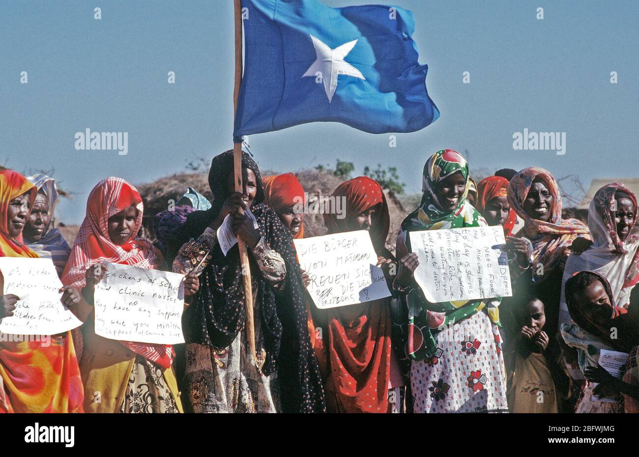 1993 - Citizens of Mataban Somalia hold signs thanking the Germans for their support during relief efforts. The Germans dug a new water well for the Somalis and the German Defense Minister dedicated the well. Stock Photo