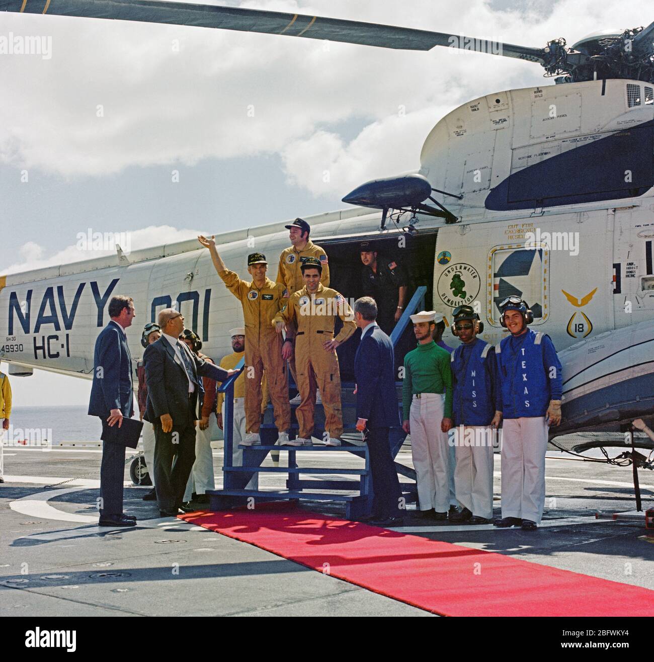 (19 Dec. 1972) --- The three Apollo 17 crewmembers arrive aboard the prime recovery ship, the USS Ticonderoga, to successfully conclude the final lunar landing mission in NASA's Apollo program. They are astronauts Eugene A. Cernan (waving), Harrison H. Schmitt (on Cernan's left), and Ronald E. Evans (standing in back). Stock Photo