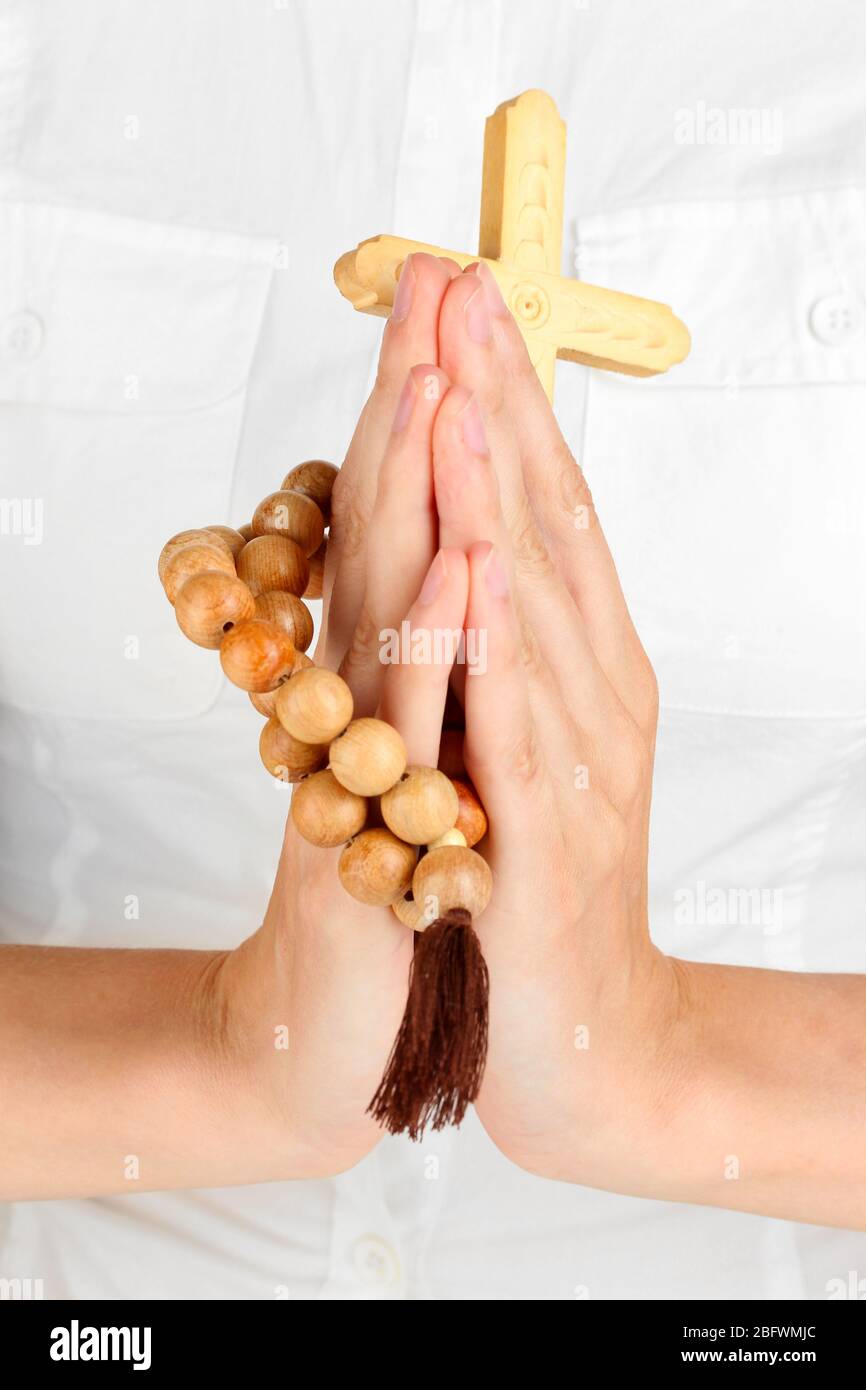 Hands in Prayer with Crucifix close-up Stock Photo