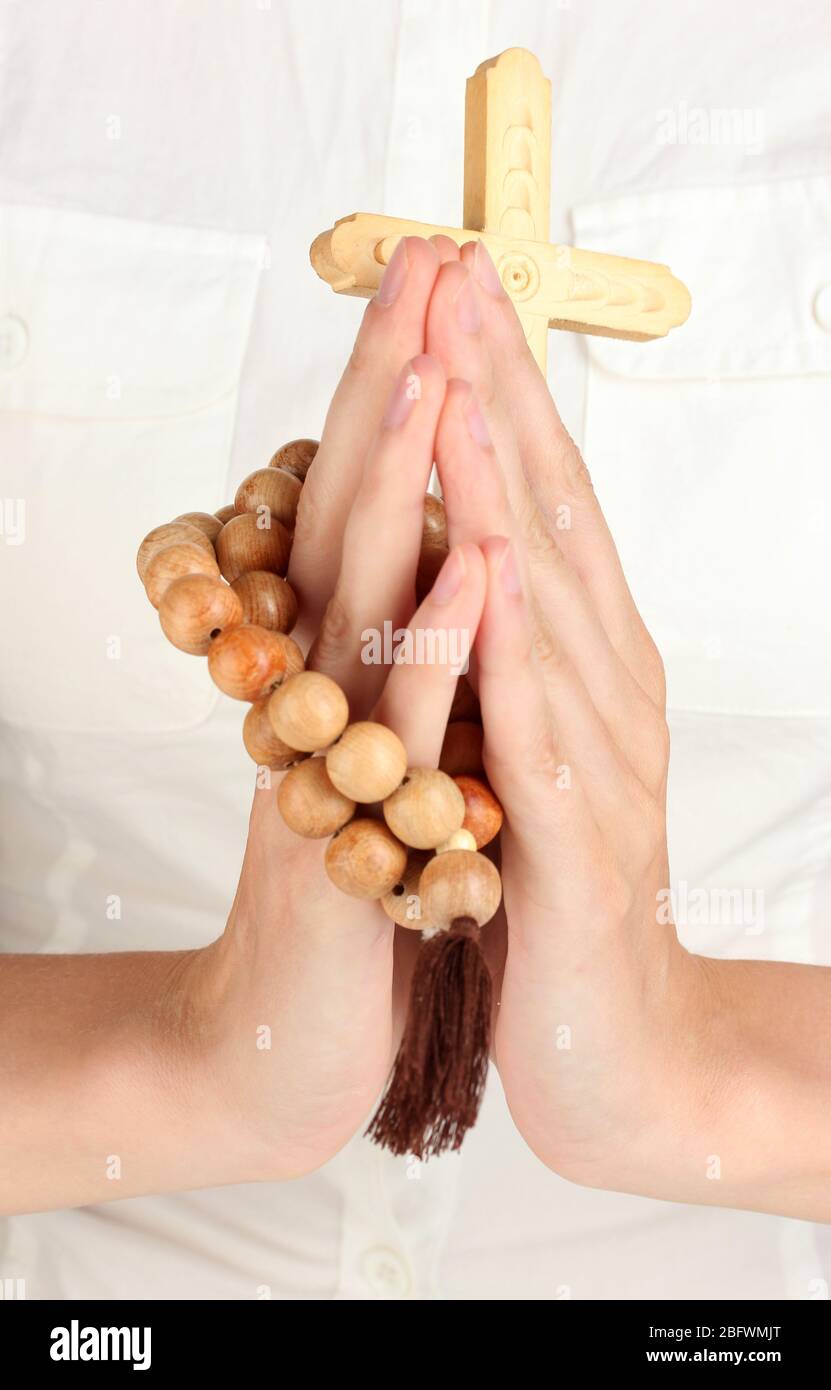 Hands in Prayer with Crucifix close-up Stock Photo
