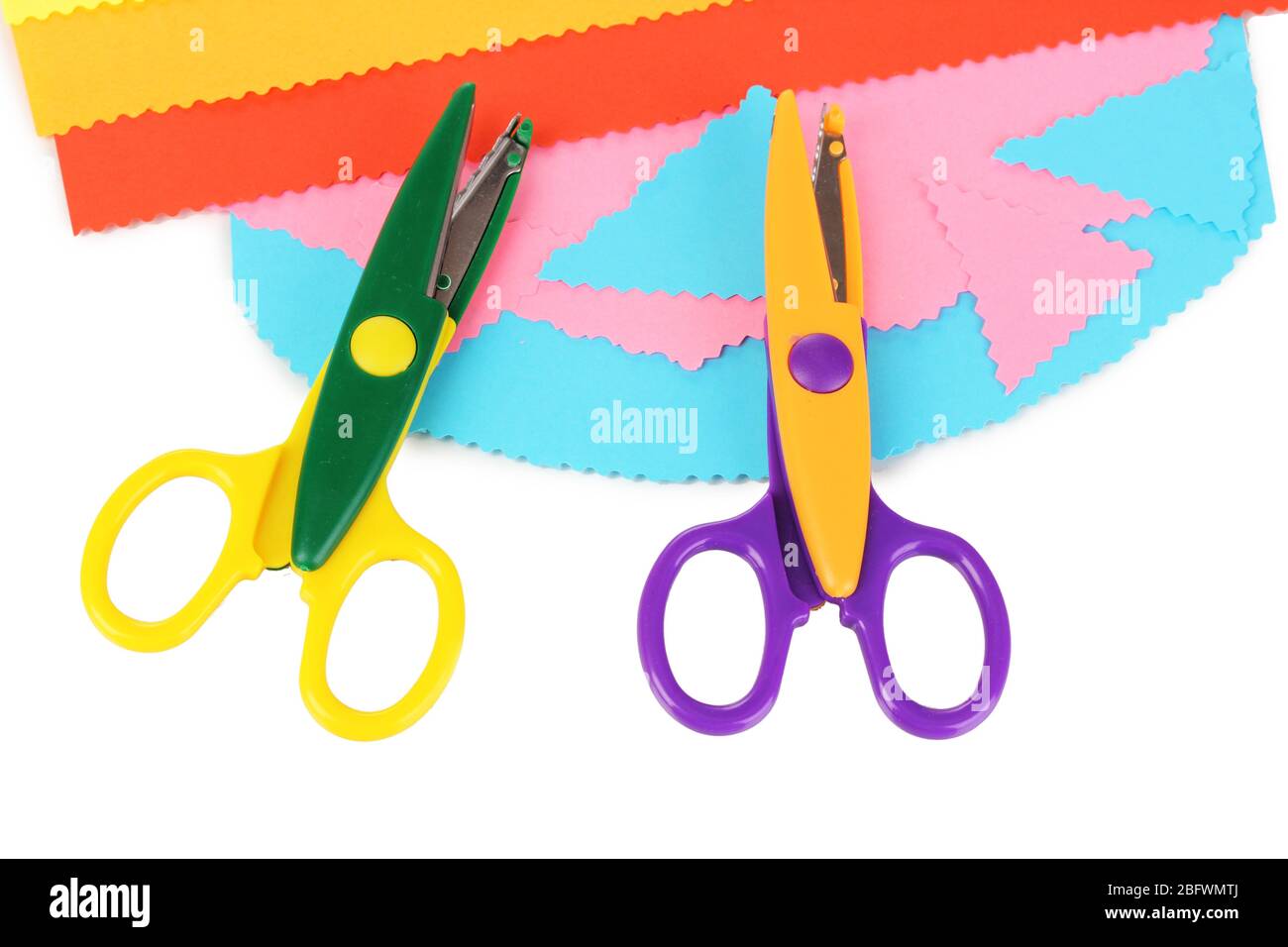 Colorful zigzag scissors with color paper isolated on white Stock Photo