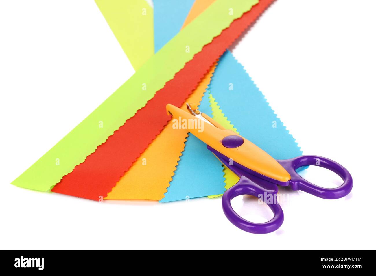 Colorful zigzag scissors with color paper isolated on white Stock Photo