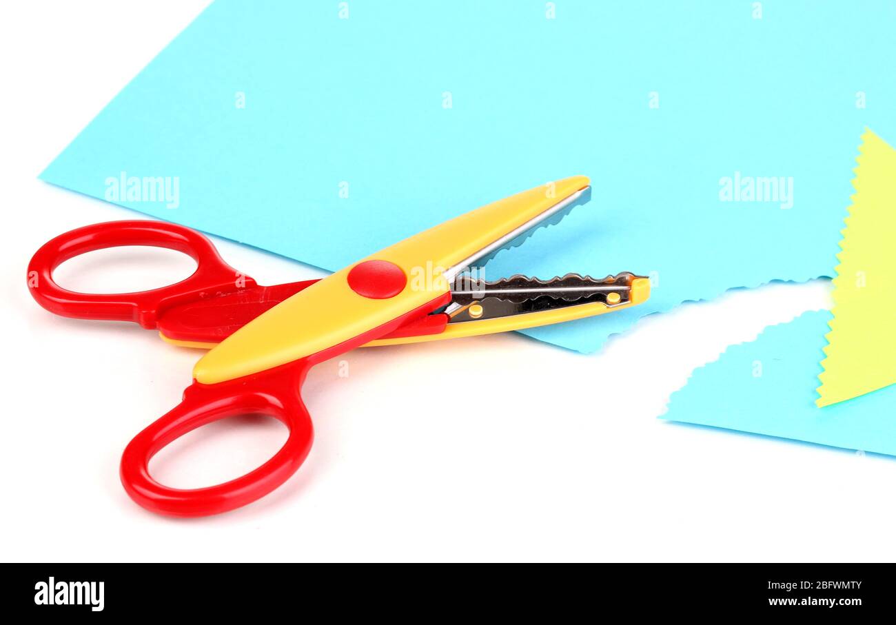 Colorful zigzag scissors with color paper isolated on white Stock Photo