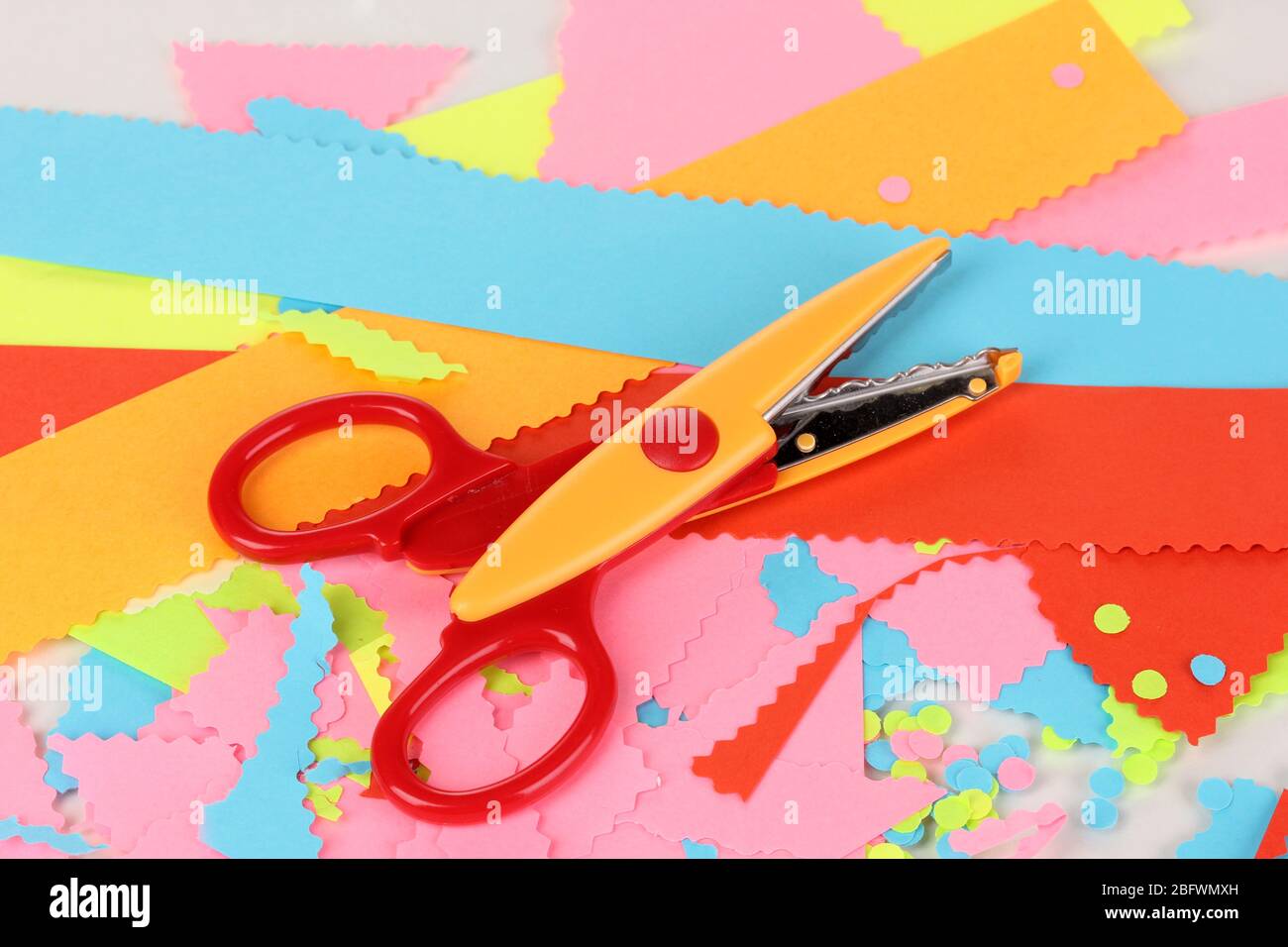 Colorful zigzag scissors with color paper isolated on white Stock Photo by  ©belchonock 13359468