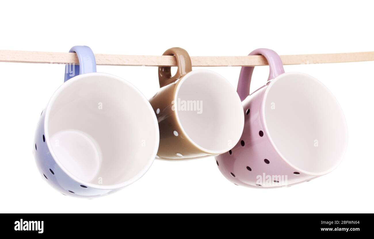 Nice cups hanging on stick isolated on white Stock Photo
