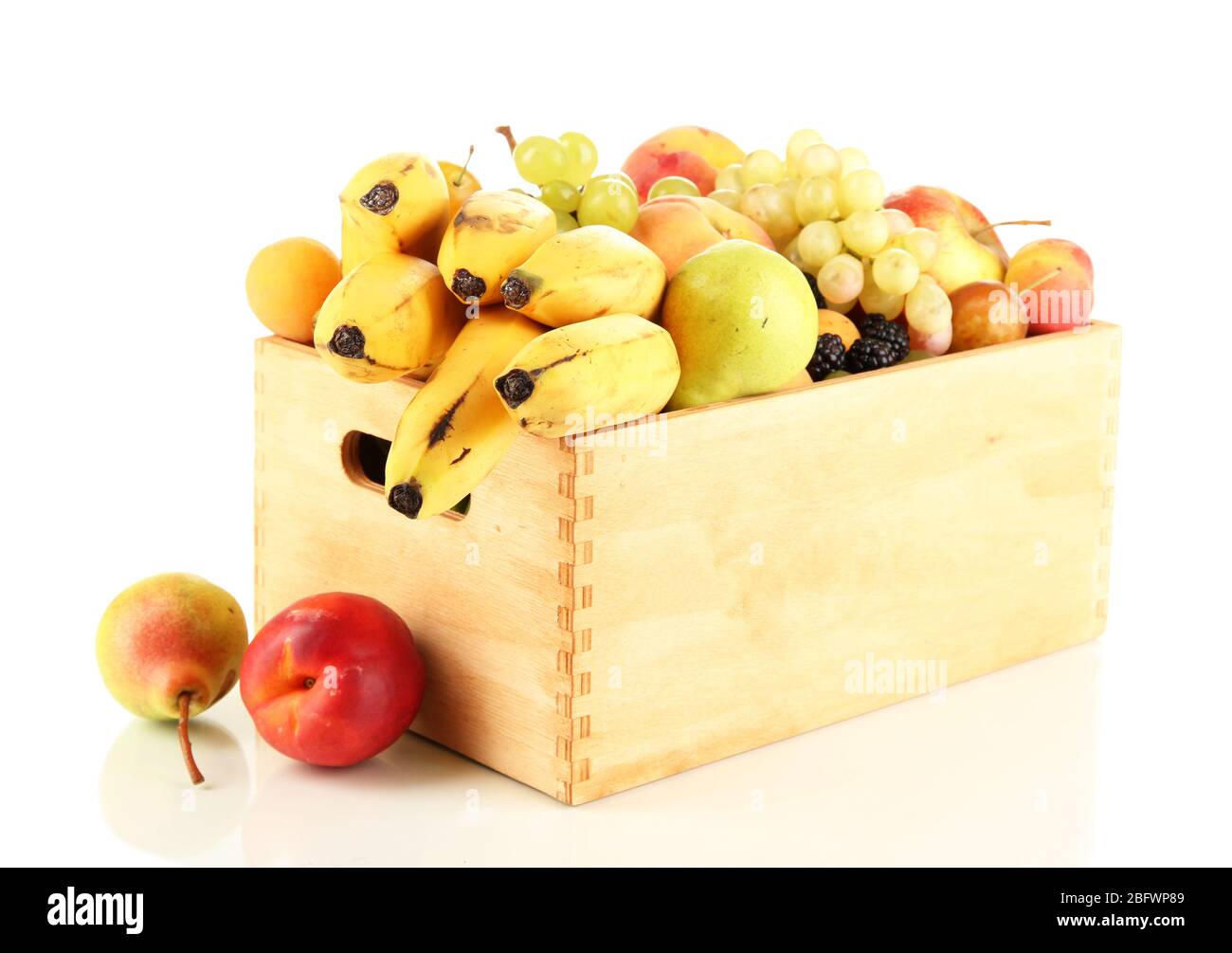 Still life of fruit in a box isolated on white Stock Photo - Alamy