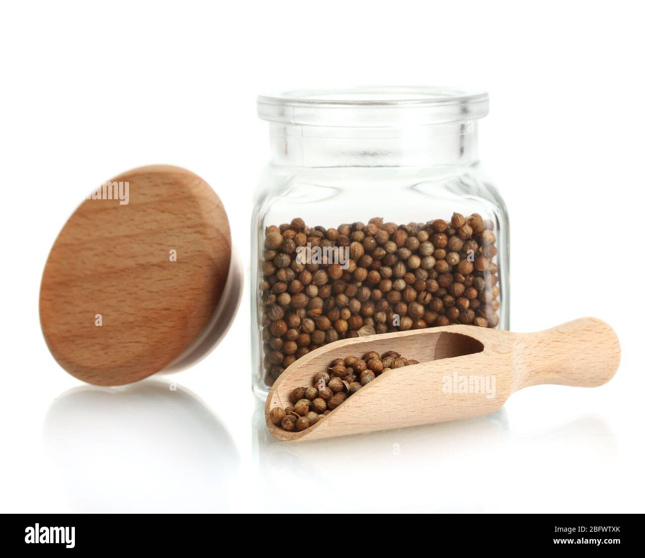 Jar of coriander seeds isolated on white Stock Photo Alamy