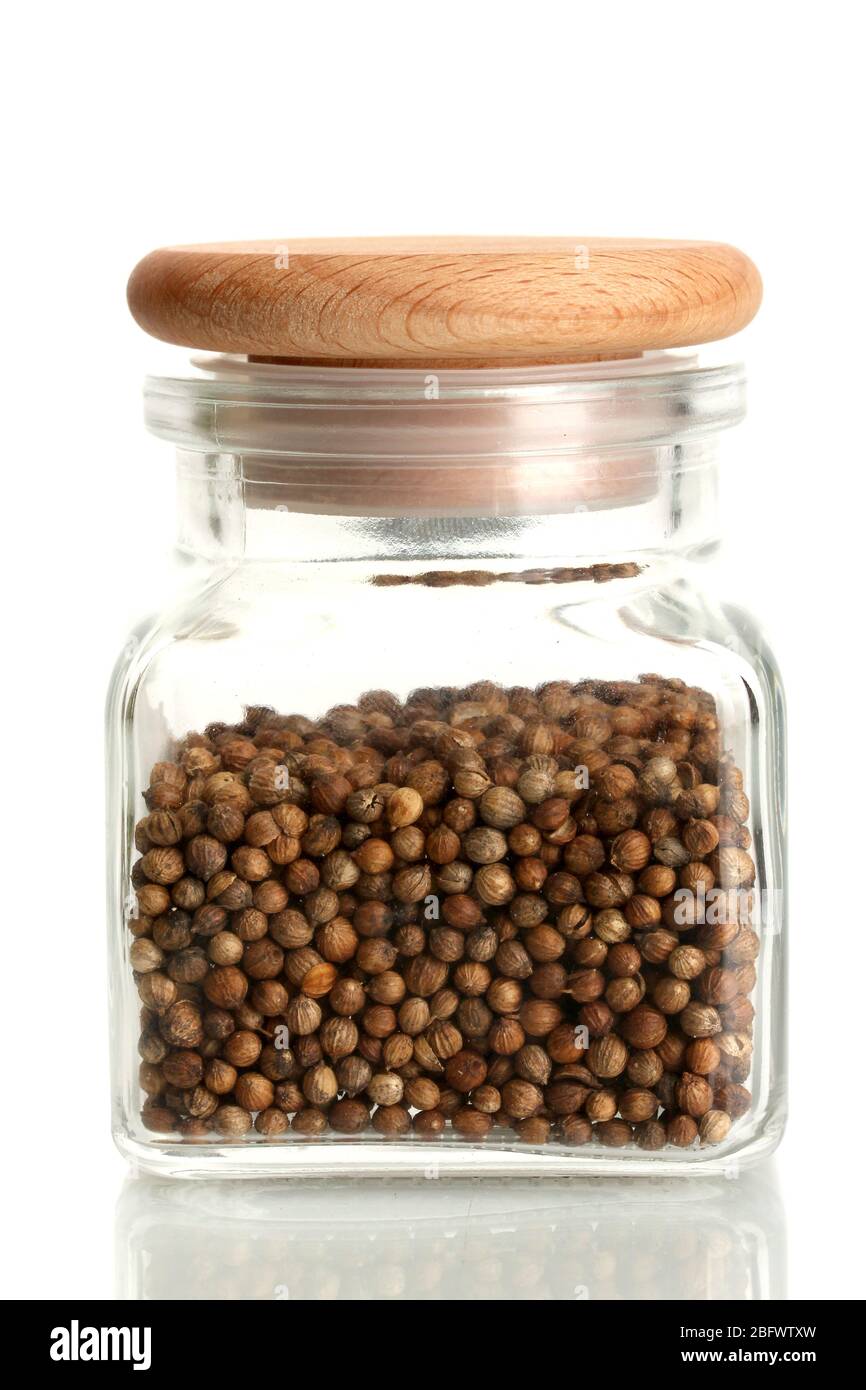 Jar of coriander seeds isolated on white Stock Photo Alamy